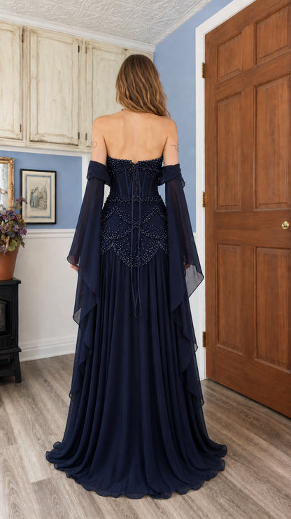 Navy blue evening gown featuring lace-up corset back detail and flowing skirt