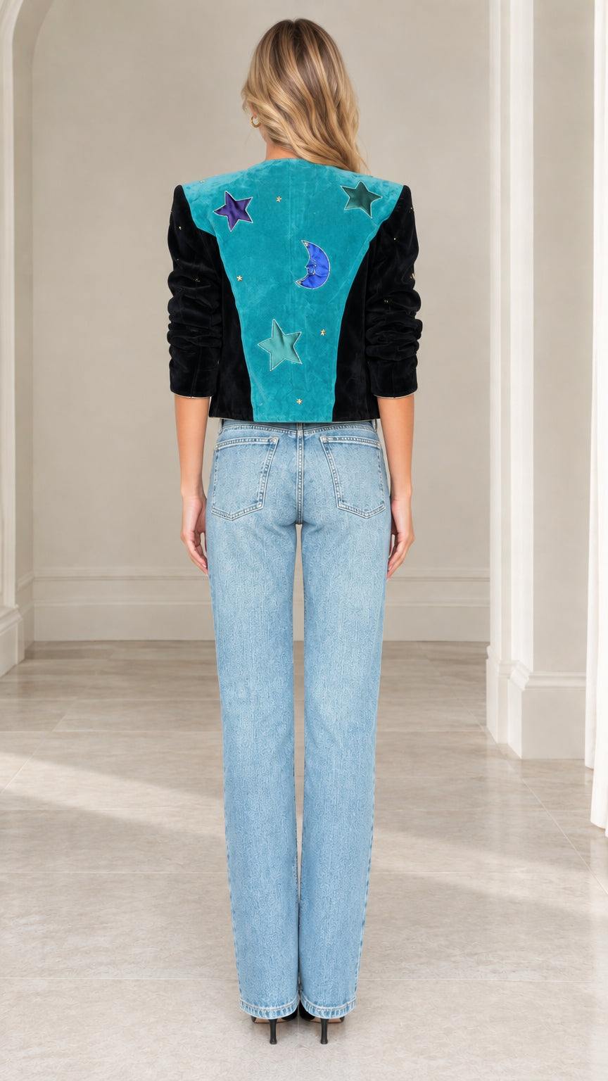 Model wearing teal celestial cropped jacket showing back star and moon patchwork details