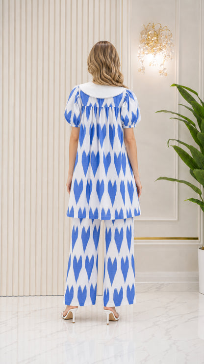 Back view of model wearing Bright Blue printed tunic top and trousers