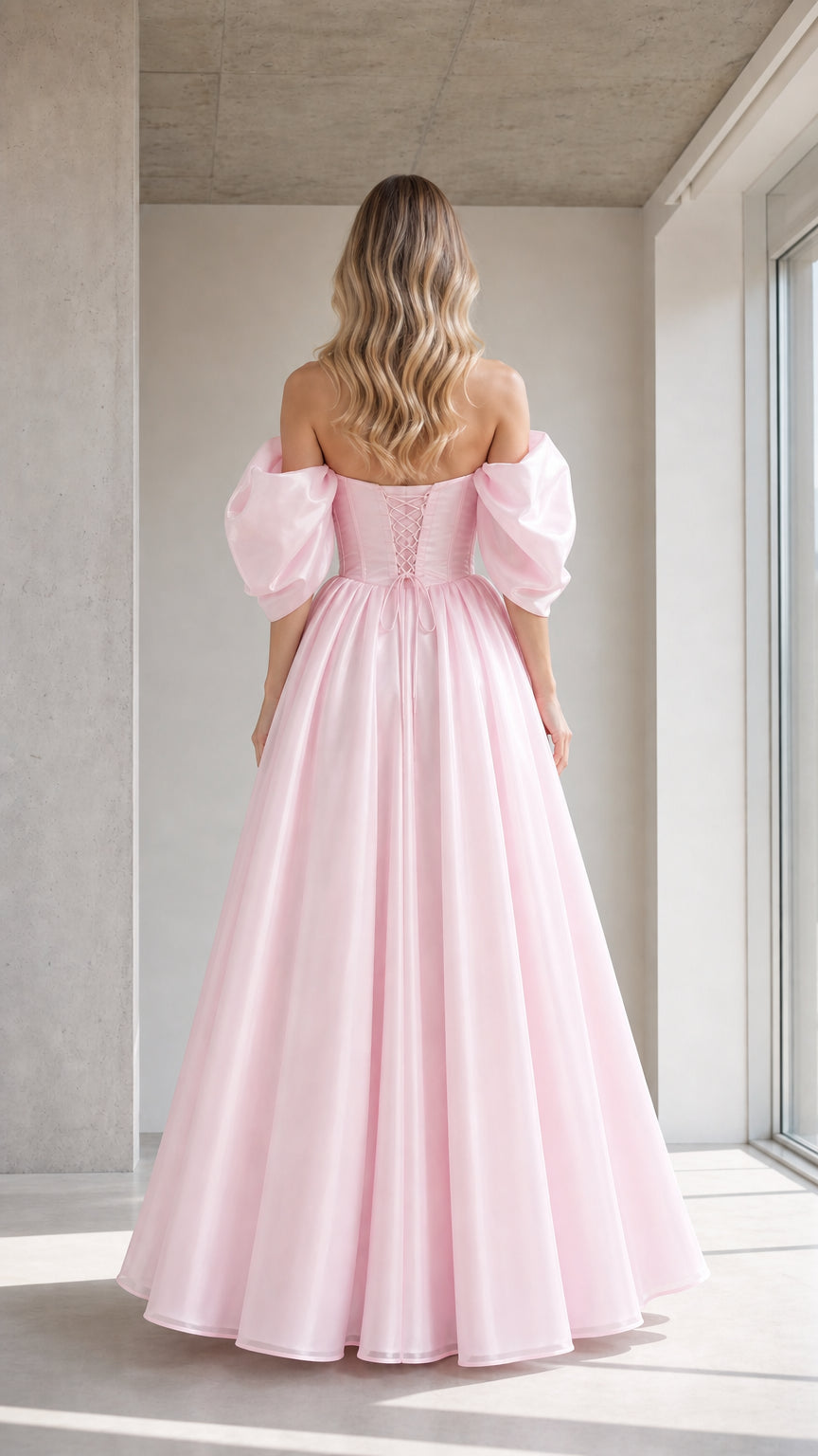 Back view of model showing lace-up detail on pink ball gown