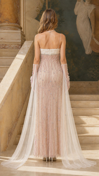 Back view showing sheer flowing cape on blush pink dress
