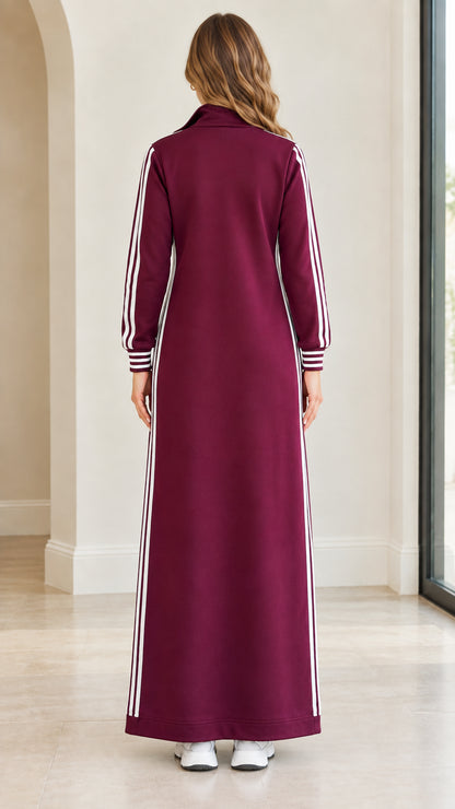Back view of woman wearing burgundy full-length sweatshirt dress