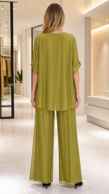 Back view of women's olive green flowing 2-piece formal set