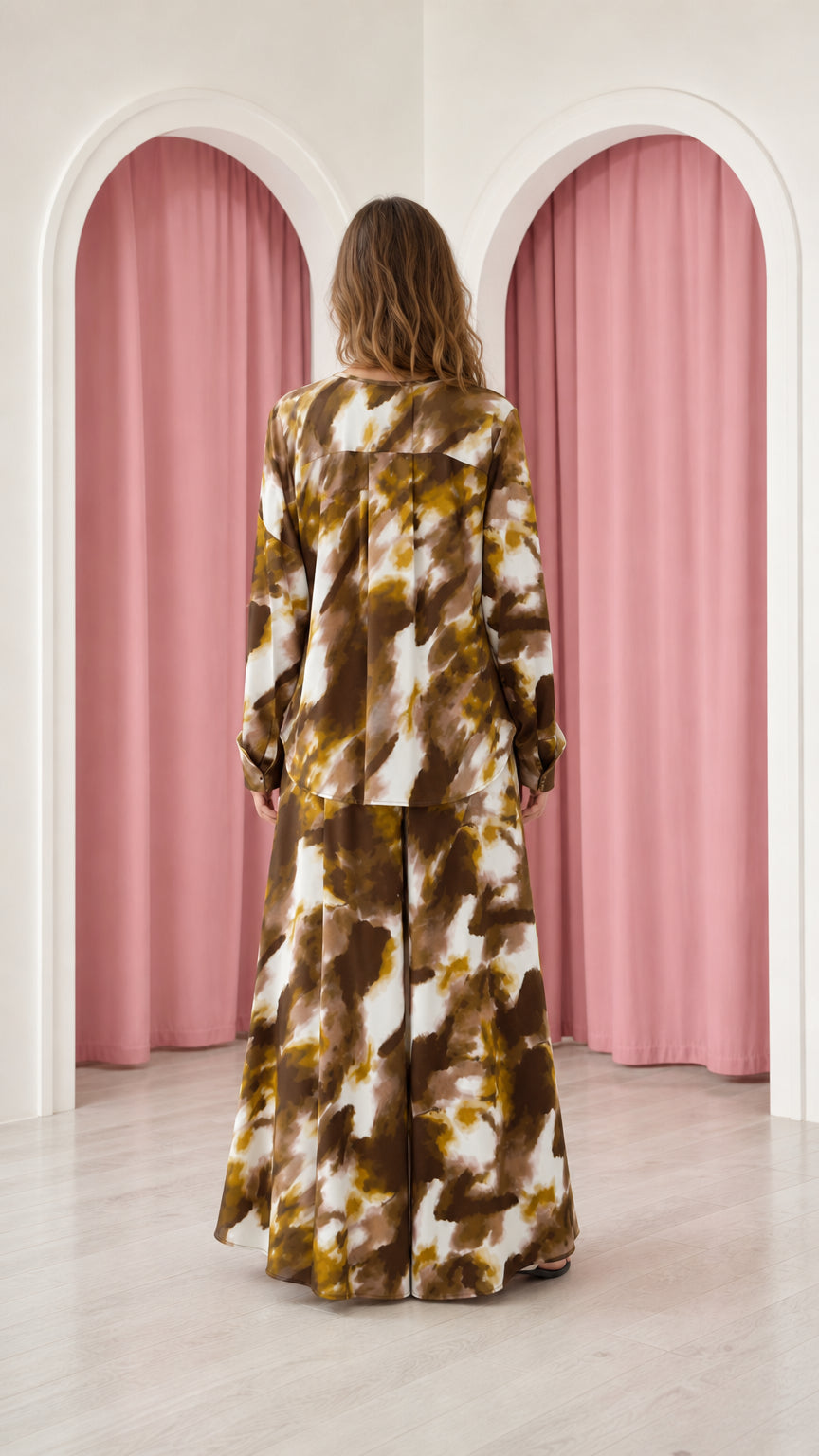 Back view of model wearing mocha brown tie-dye long sleeve top and wide pants