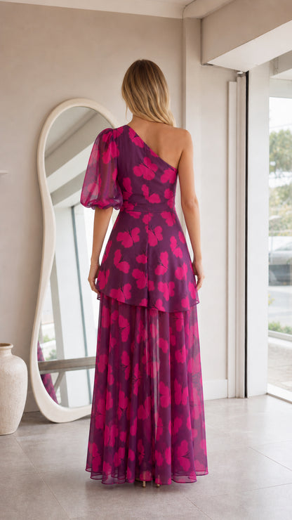 Back view of model in magenta butterfly print one-shoulder tiered maxi dress
