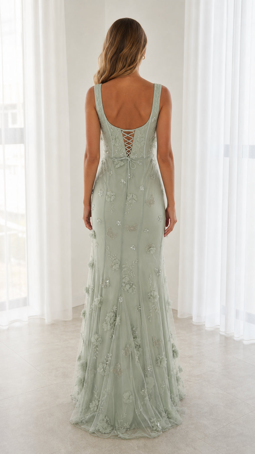 Back view of model in Sage Green maxi gown showing lace-up corset back