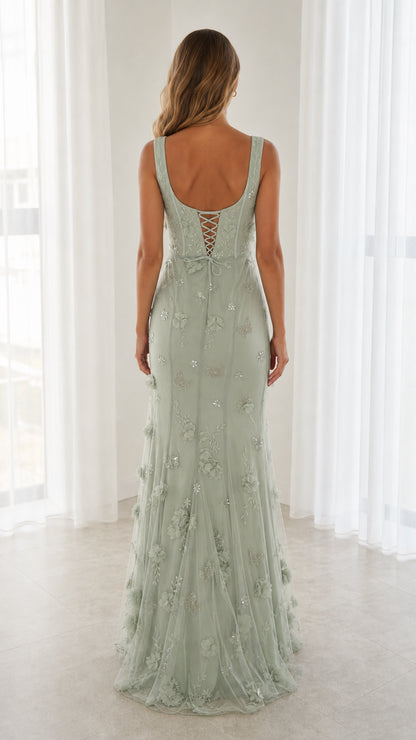 Back view of model in Sage Green maxi gown showing lace-up corset back
