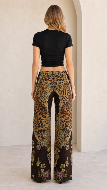 Back view of model showing the fit and print pattern of brown wide leg pants