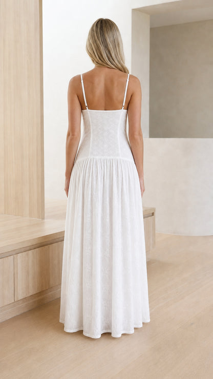 Back view of white spaghetti strap drop-waist embroidered maxi dress