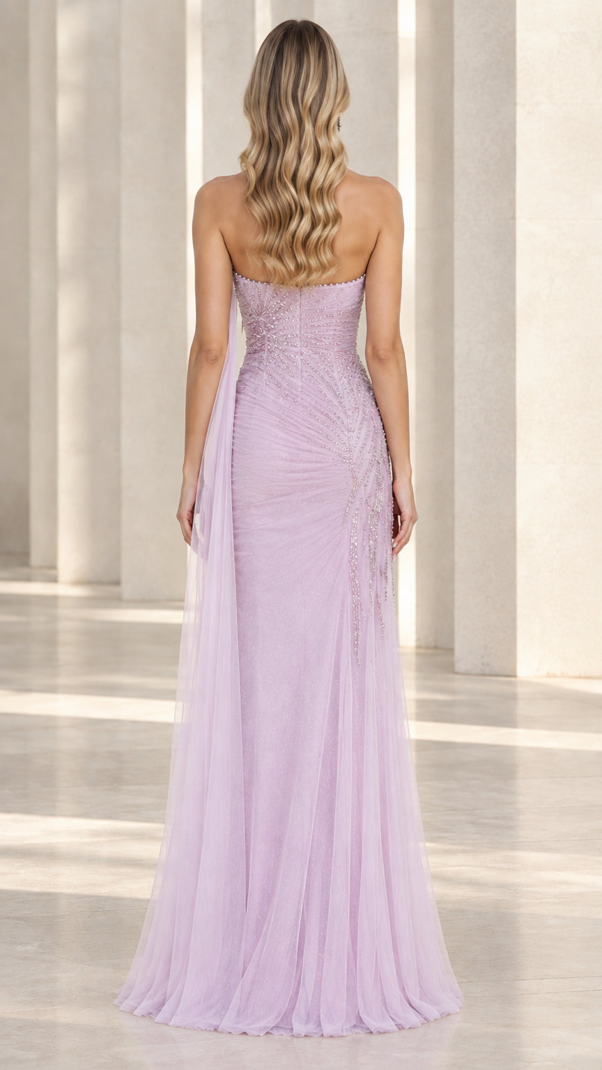 Back view of lavender strapless tulle gown showing flowing cape train