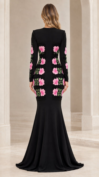 Back view of black long sleeve formal gown featuring floral placement details