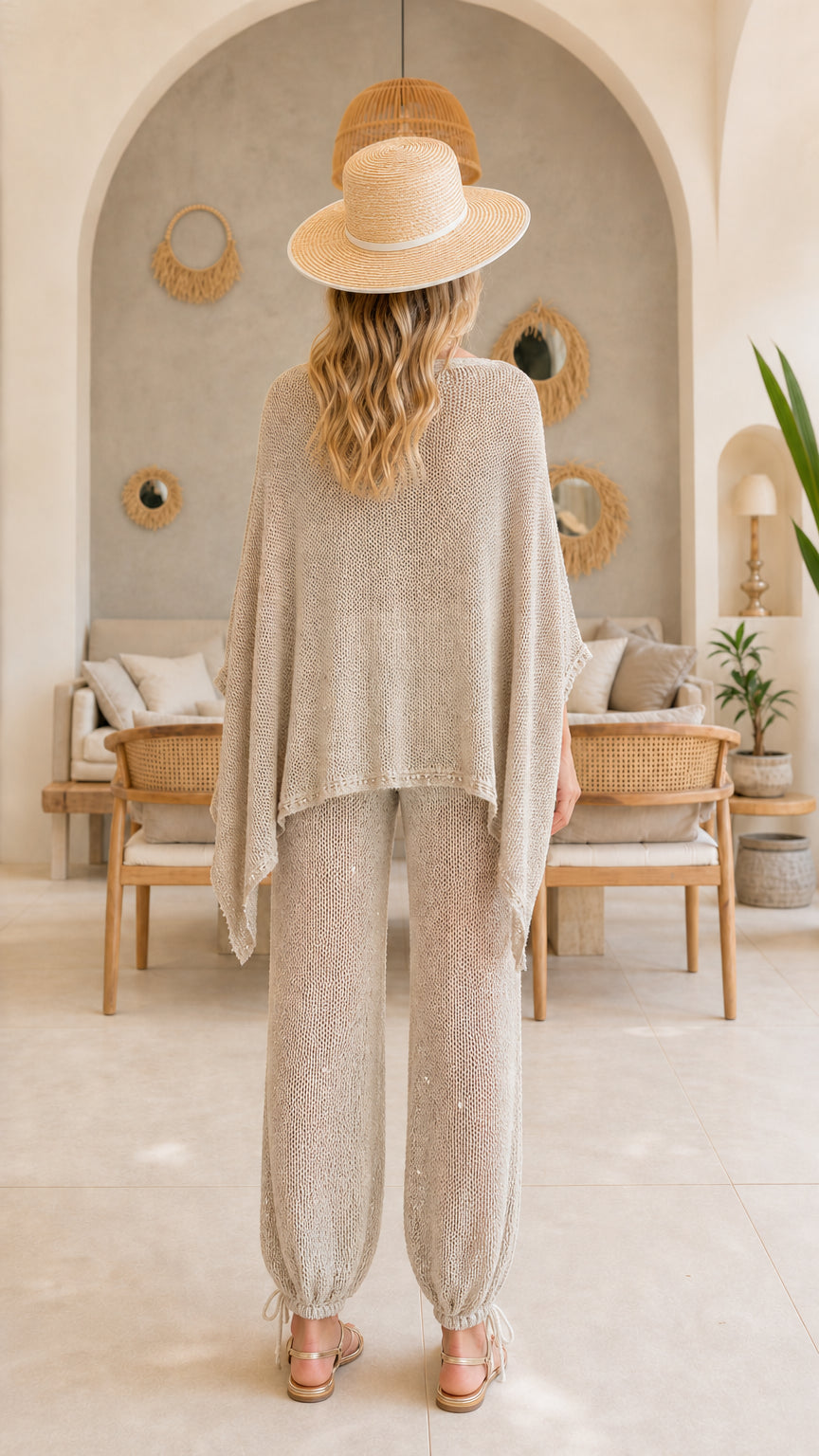 Back view of beige draped knit poncho top and matching knit pants set