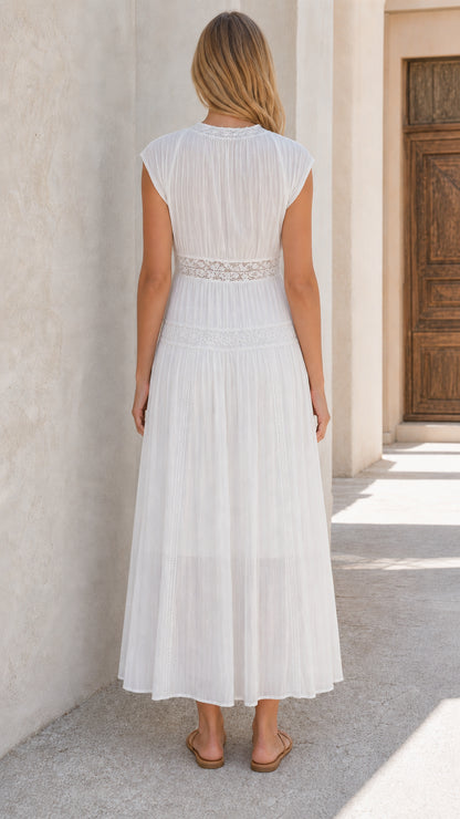 Back view of woman wearing white lace panel maxi dress