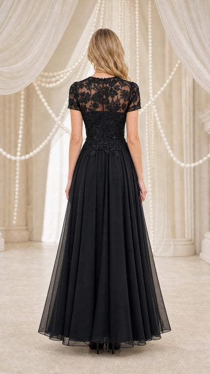 Model wearing black formal maxi dress, back view