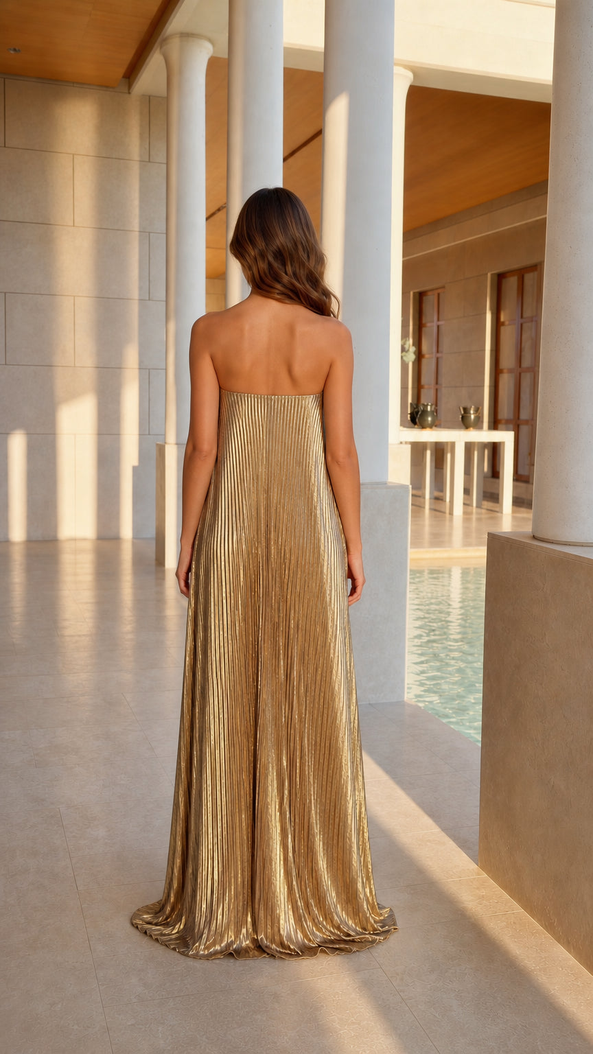 Back view of model in gold metallic pleated evening gown