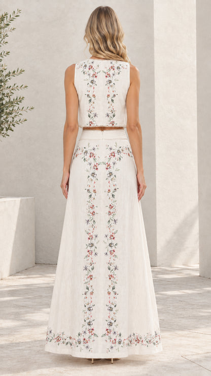 Back view of white floral embroidered crop top and flowing maxi skirt