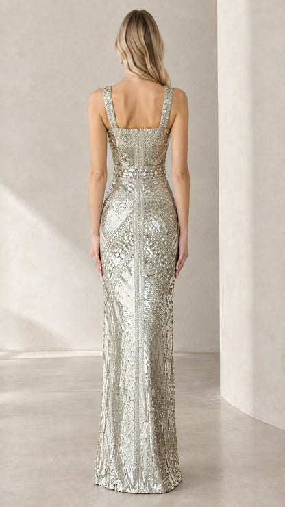 Back view of woman wearing silver sequin maxi gown showing square back neckline