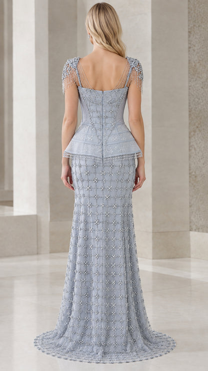 Back view of model in dusty blue corset gown showing low back and train