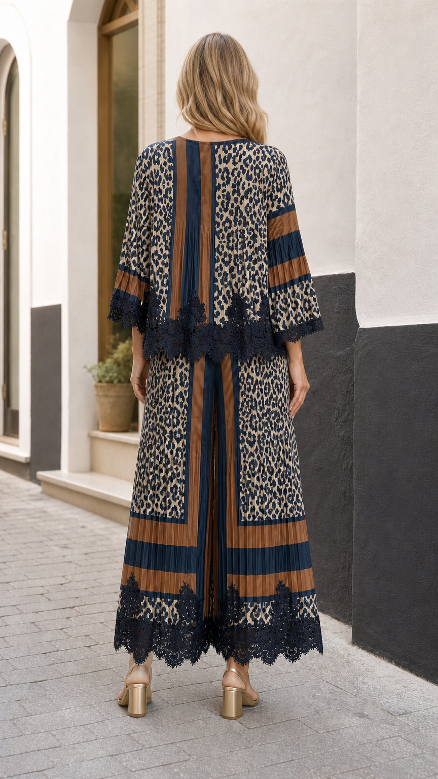 Back view of model wearing the pleated animal print top and wide-leg trousers