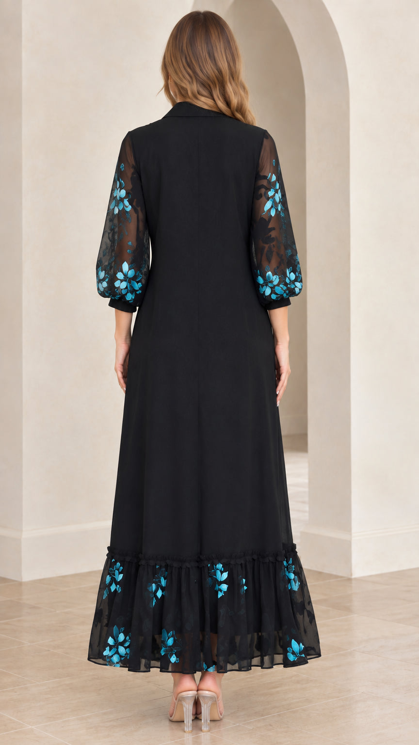 Back view of black maxi dress showing sheer embroidered 3/4 sleeves and tiered hem