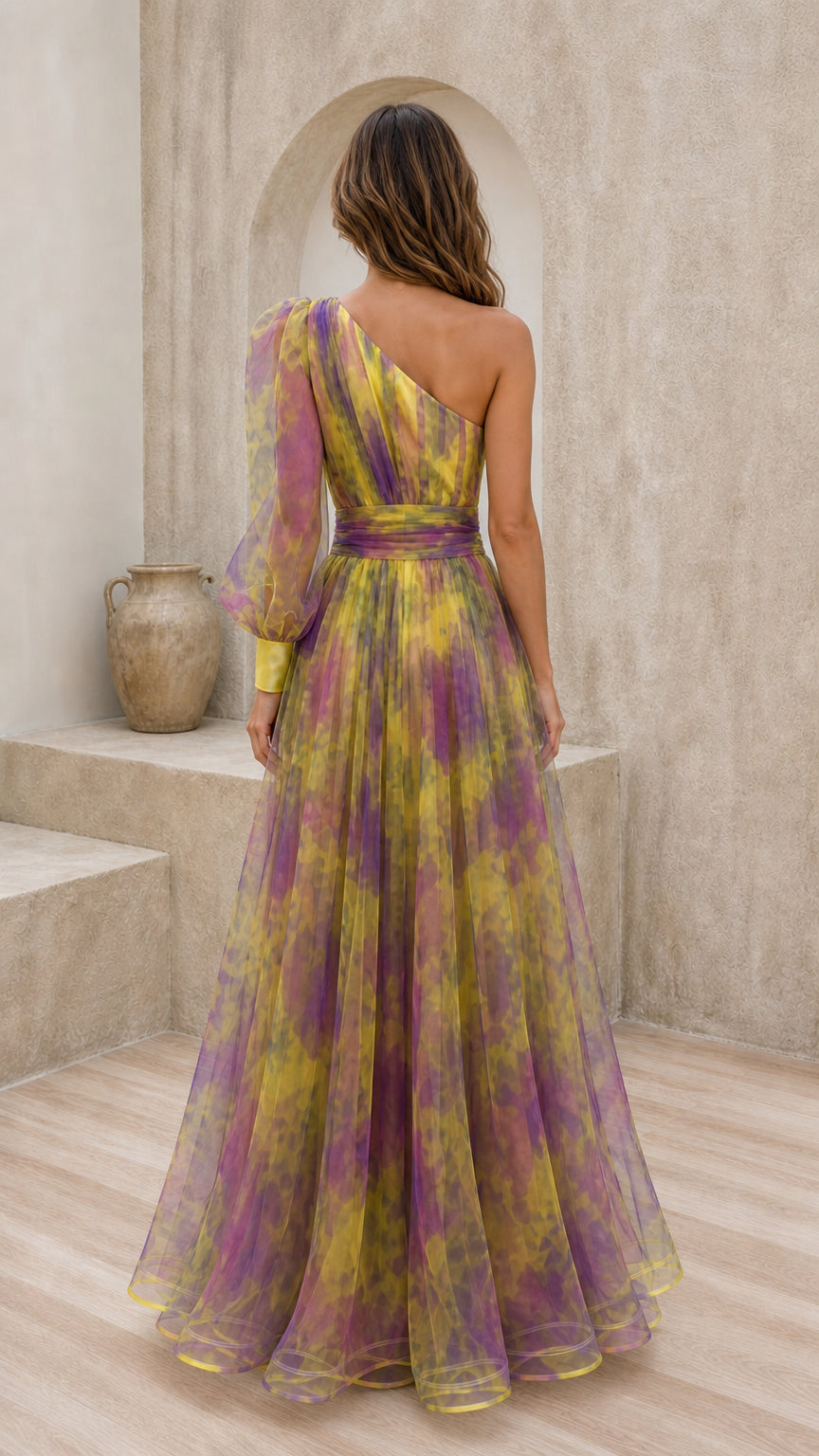 Back view of yellow multi one-shoulder gown with voluminous sleeve