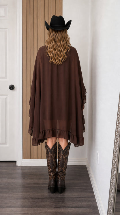 Back view of woman in brown cape mini dress