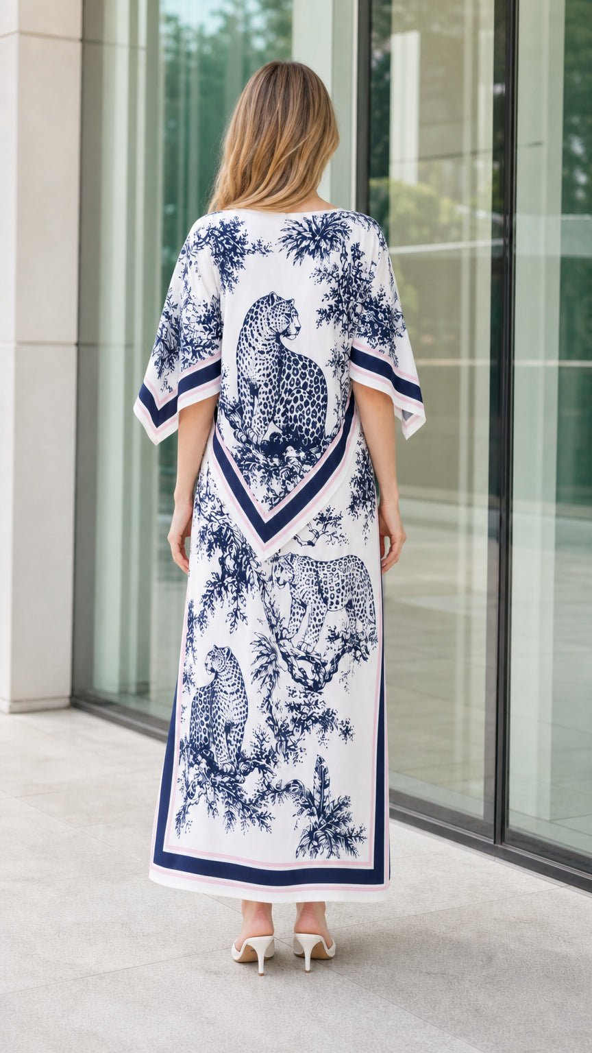 Back view of woman wearing white and navy scarf print kaftan dress