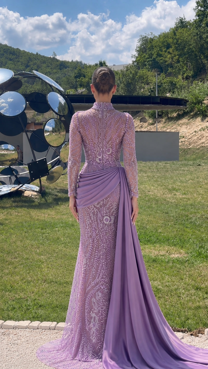 Back view of model in lilac long sleeve beaded formal gown with sweeping train