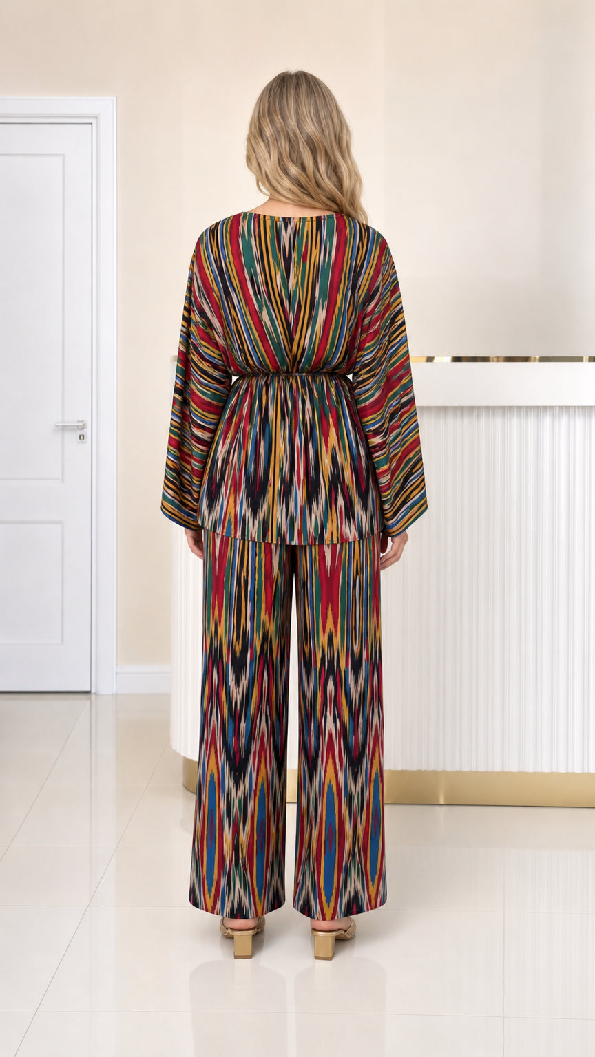 Back view of woman wearing multicolor ikat printed top and wide leg trousers