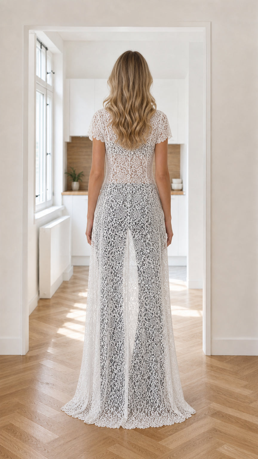 Back view of model wearing sweeping white floral lace maxi duster