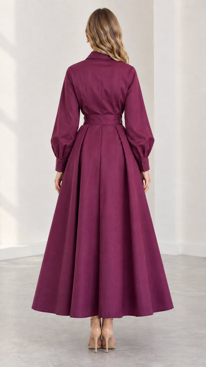 Back view of plum long sleeve maxi dress showing flared skirt silhouette