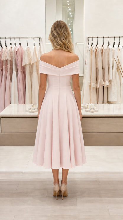 Back view of blush pink off-shoulder midi dress