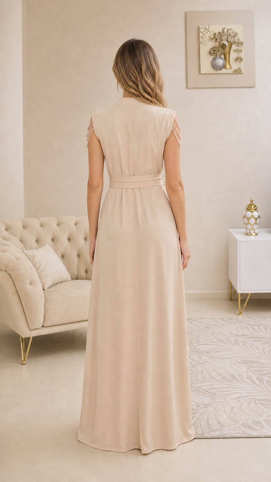Back view of beige sleeveless maxi gown showcasing smooth silhouette