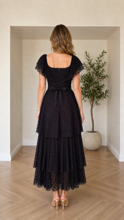 Back view of black square neck maxi dress showing waist tie