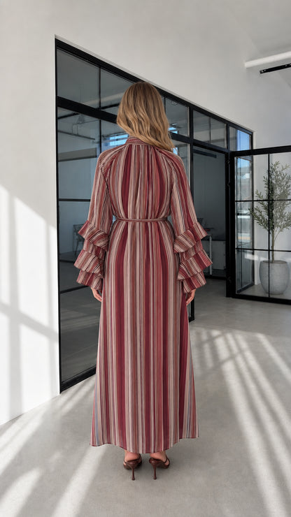 Model wearing burgundy striped maxi dress back view