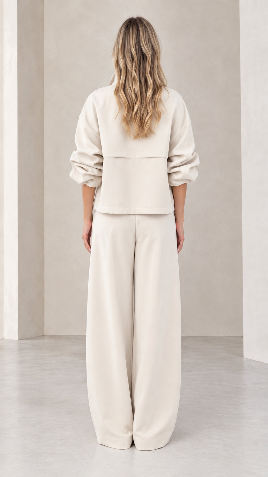Back view of woman wearing beige relaxed wide-leg matching two-piece set