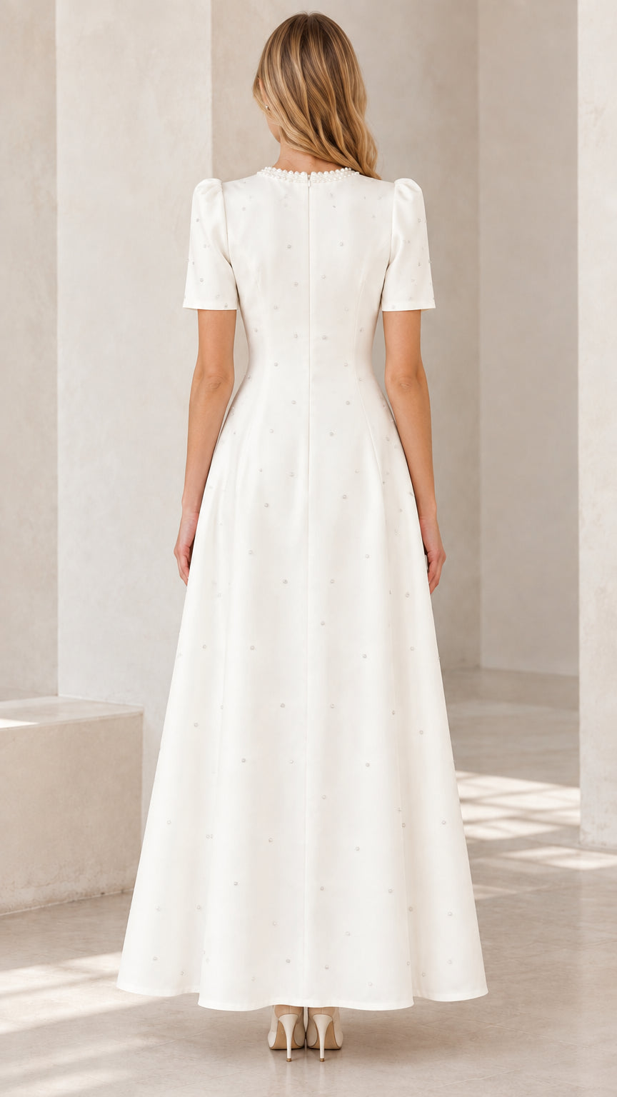 Back view of model in ivory short sleeve maxi dress showing tailored silhouette and zip closure