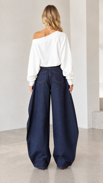 Back view of women wearing high-rise dark blue wide-leg denim pants with classic rear pockets