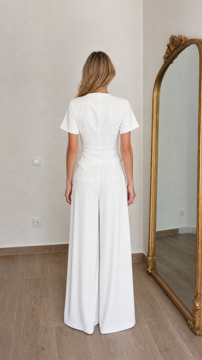 Back view of woman wearing white two piece trouser set