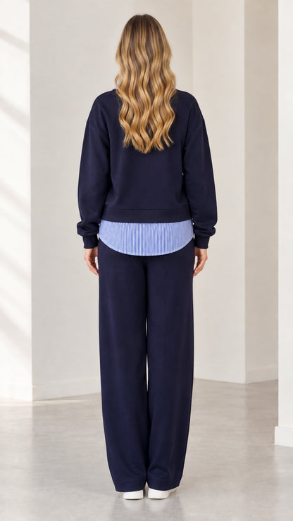 Back view of navy blue loungewear set with layered striped hem detail