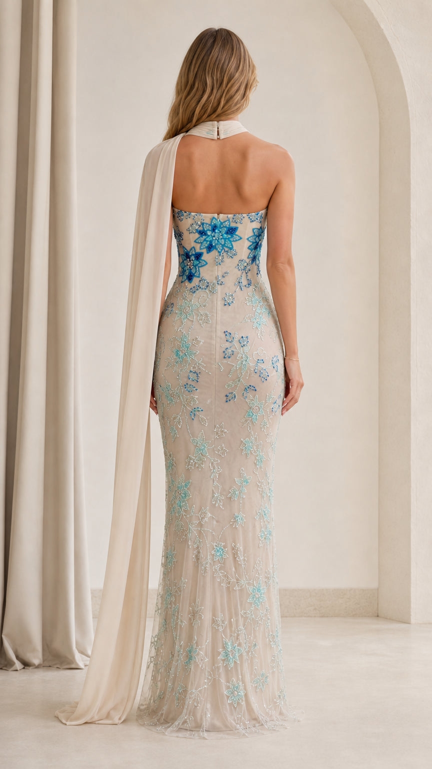 Back view of champagne formal gown showing attached chiffon scarf cape