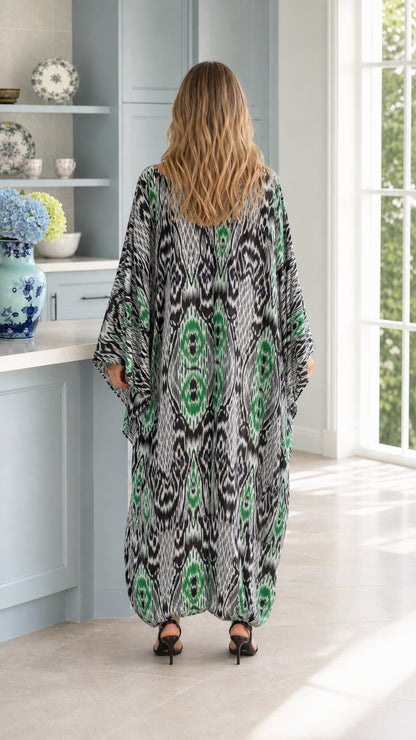 Back view of woman wearing emerald green Ikat print maxi kaftan dress
