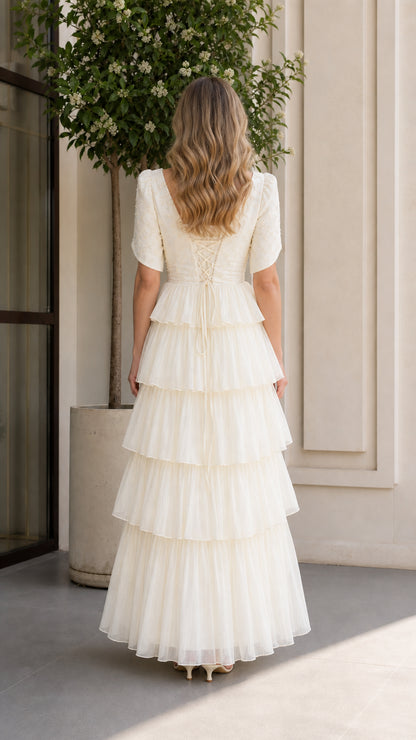 Ivory formal tiered maxi gown back view with lace-up detail