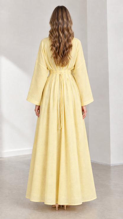 Back view of woman wearing Light Yellow maxi dress showing adjustable waist ties