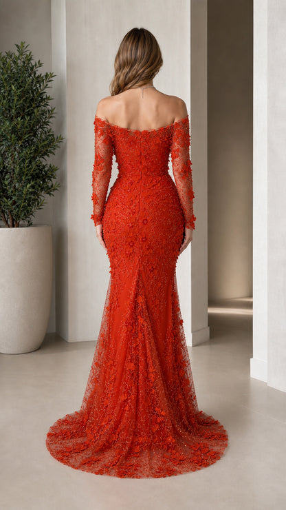 Back view of woman showcasing the flared train of the red mermaid gown