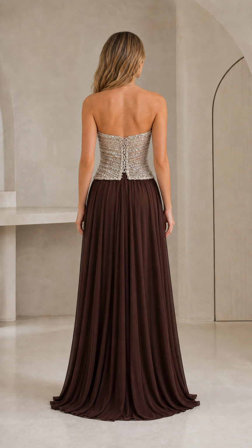 Back view of strapless chocolate brown chiffon gown showing structured bodice