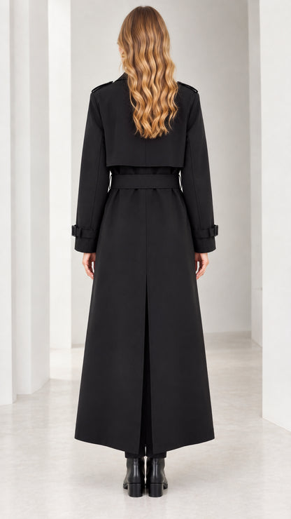 Back view of woman in black maxi trench coat showing belted waist and back vent