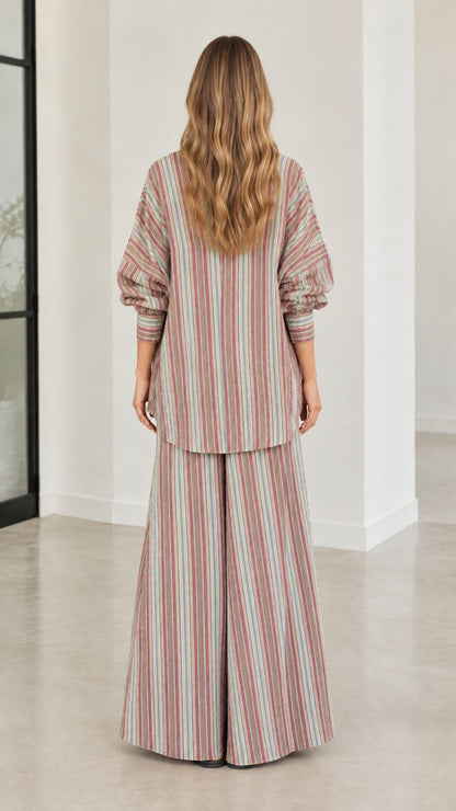 Back view of model wearing relaxed fit striped button-down tunic and wide-leg pants