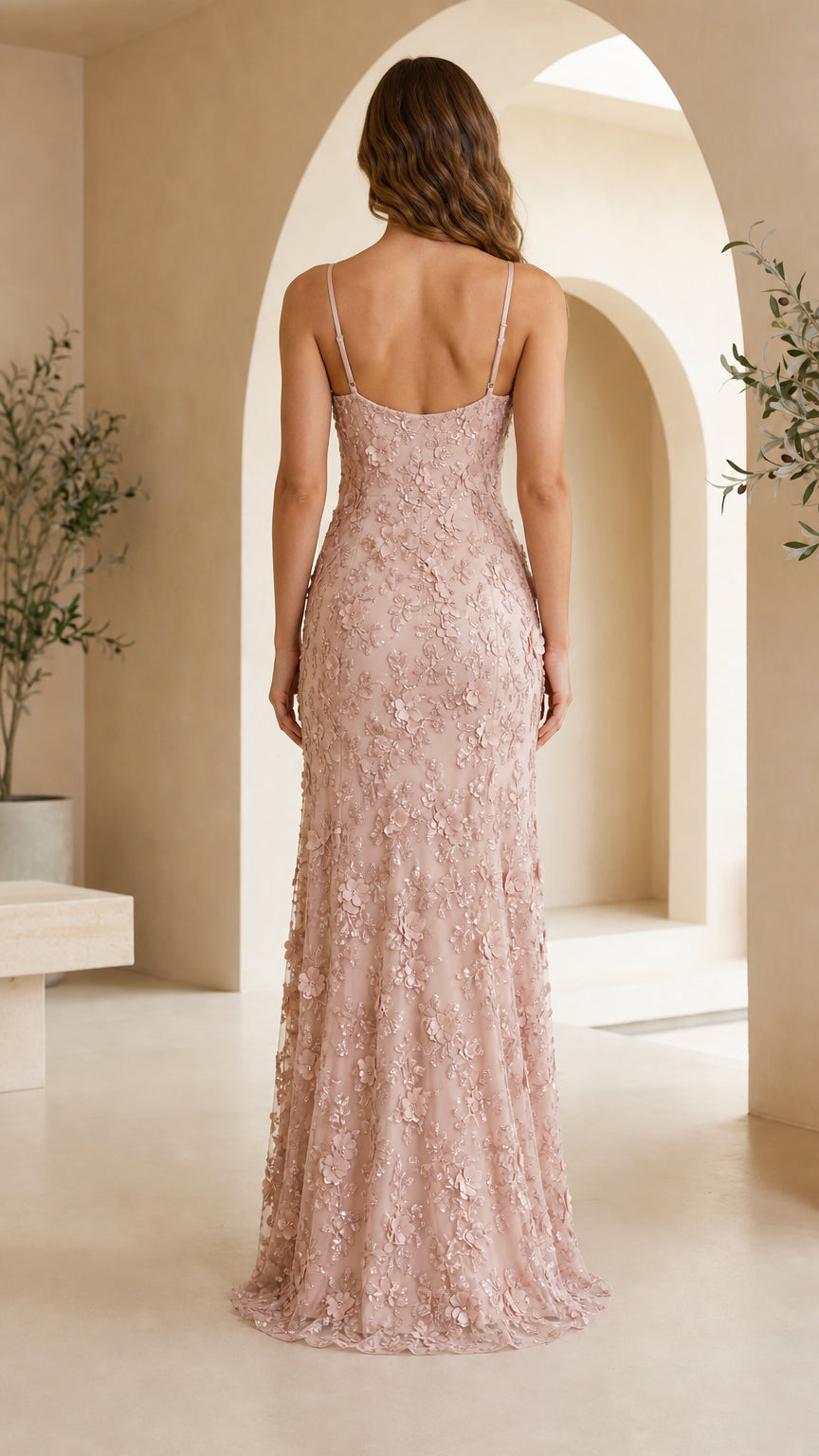 Back view of model wearing dusty pink spaghetti strap low-back formal gown