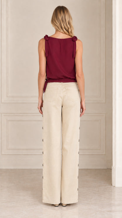 Back view of women's burgundy sleeveless top with shoulder ties and solid back